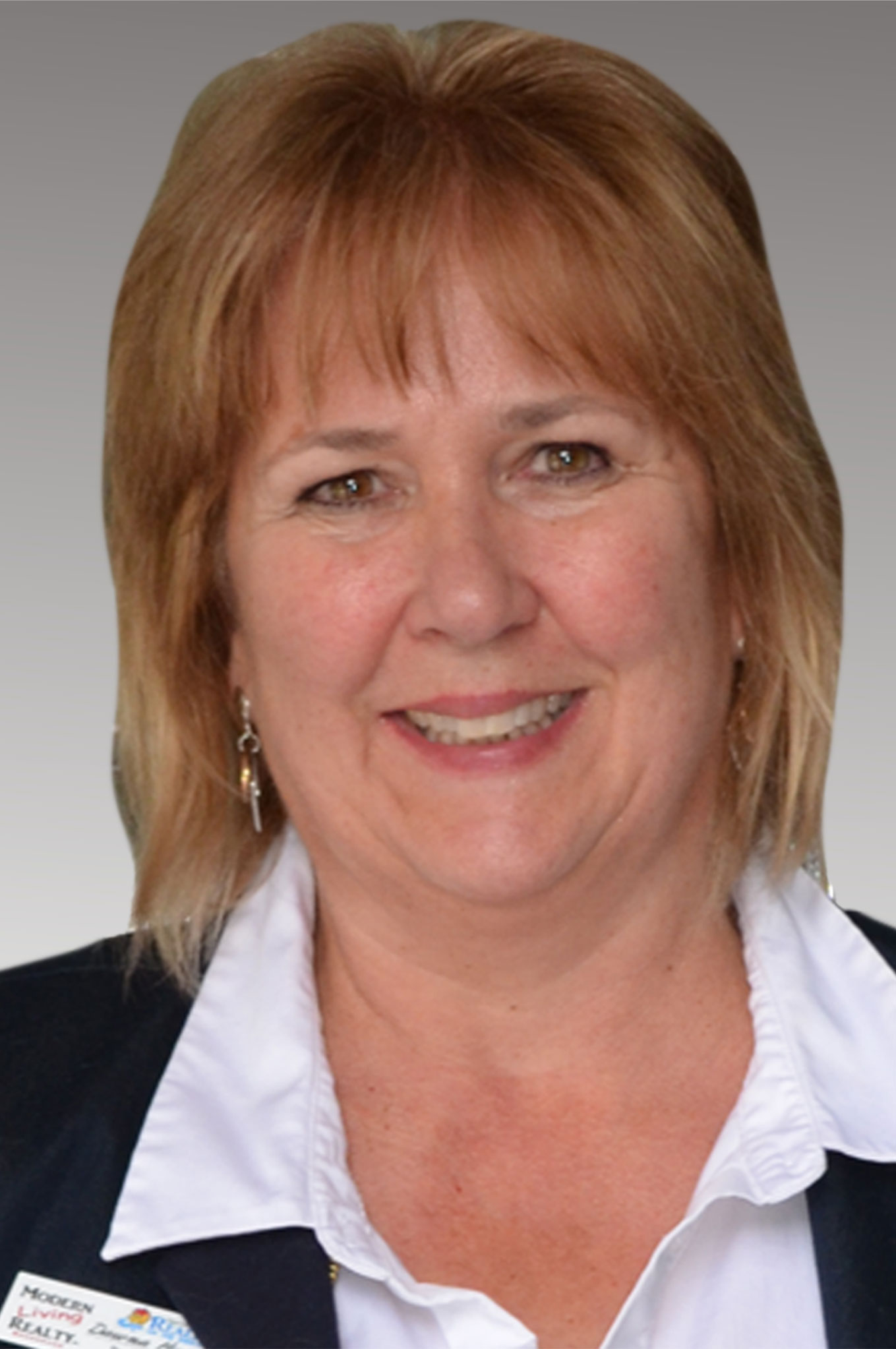 Donna Hamilton sitting at desk on the phone, Owner of Modern Living Realty Brokerage